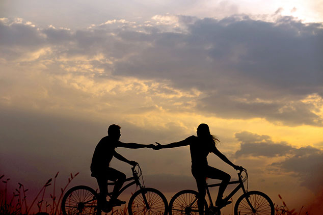 a couple riding a bike